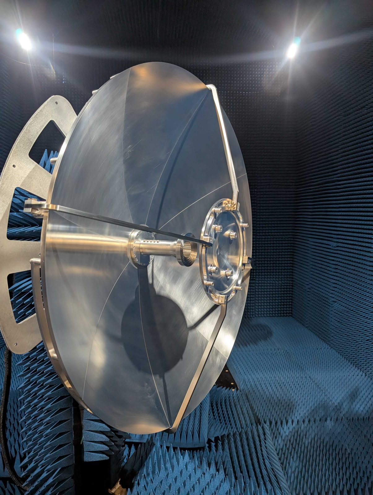 Precision reflector antenna on positioner in darkened anechoic chamber